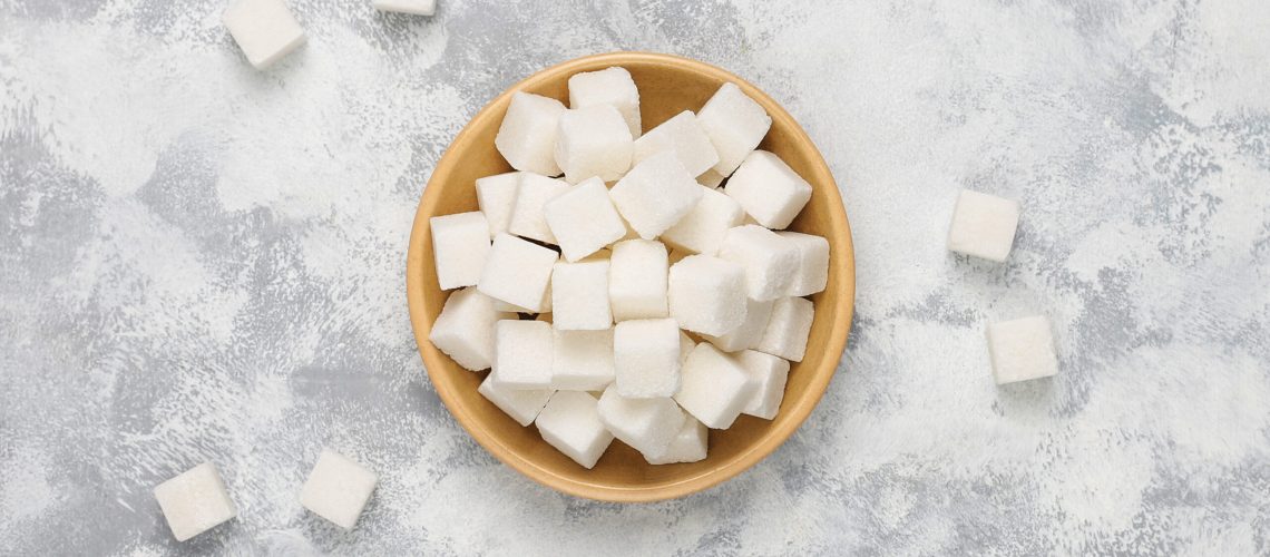 White sugar cubes on concrete background,top view